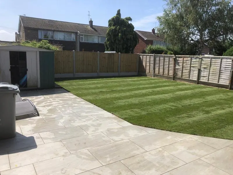 New patio and striped lawn in a back garden, from a customer's TrustATrader review